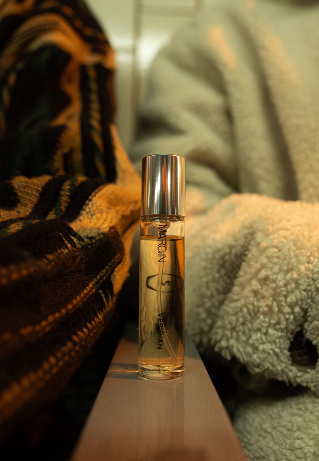 Margin Veridian bottle styled on knit textures