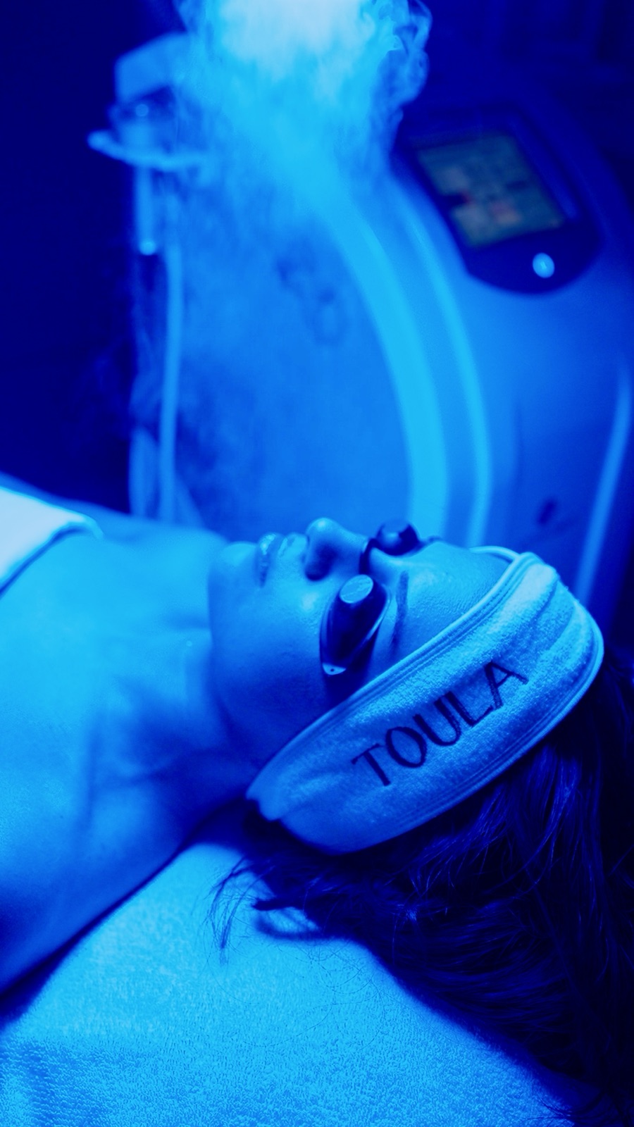 Cryo facial under blue light at Toula